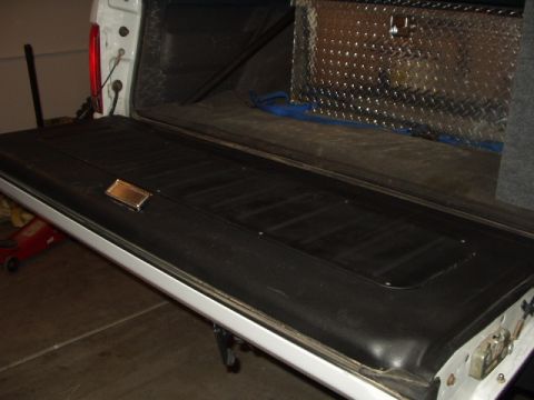 1993 Ford Bronco - The tailgate and bed of a 1993 Ford Bronco are visible, with a diamond plate toolbox inside the bed.