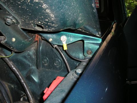 1996 Ford Bronco - Engine bay detail showing wiring and a metal bracket with a red protective cover.
