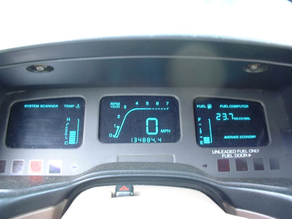 Digital dash cluster showing 0 MPH, 134884.4 miles, and fuel computer reading 23.7 MPG average economy