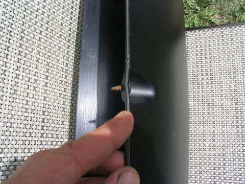1986 Ford Bronco - Close-up of a black trim piece with a screw, showing the Supermotors.net logo at the bottom right.