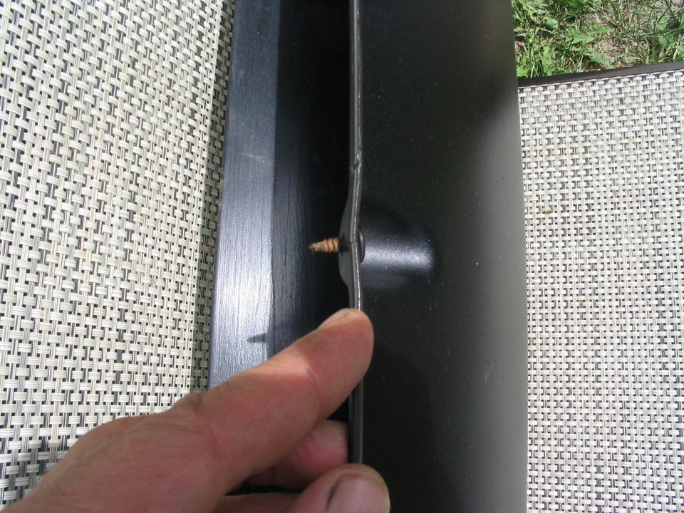 Black trim piece with screw, Supermotors.net logo visible