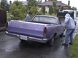 1968 Ford Ranchero - Purple 1968 Ford Ranchero pickup truck with two people standing nearby, being loaded onto a tow truck.