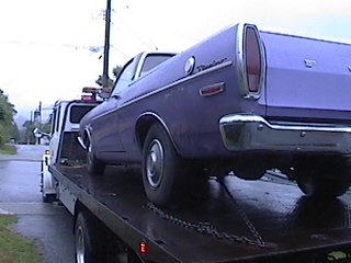 1968 Ford Ranchero - Purple 1968 Ford Ranchero being towed on a flatbed truck.