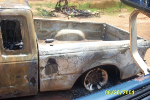 1979 Ford F-150 - This pickup truck sustained significant fire damage, as evidenced by the charred exterior and interior.