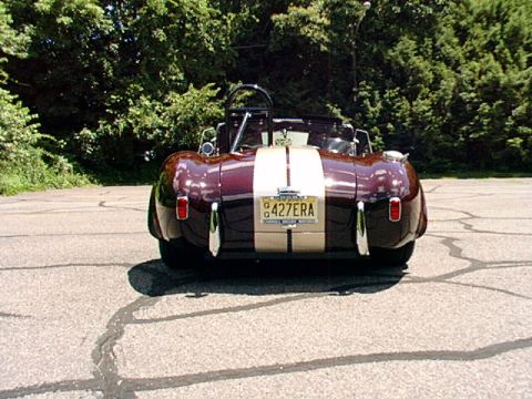 1967 Ford 427 - Rear view of a 1967 Ford 427 Cobra replica with dual racing stripes and custom license plate.
