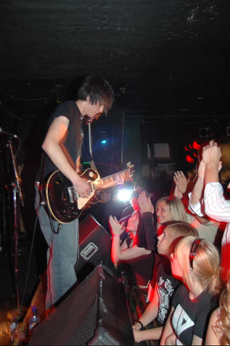 2000 Jeep Liberty - A musician performs live on stage with a crowd watching and clapping.