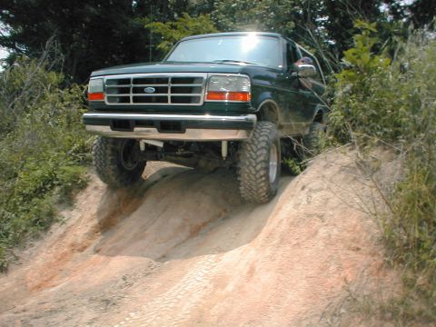 1995 Ford Bronco - This green 1995 Ford Bronco navigates a steep, sandy incline during an off-road excursion.