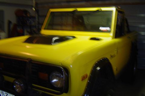 1974 Ford Bronco - Front 3/4 view of a yellow 1974 Ford Bronco in a garage.