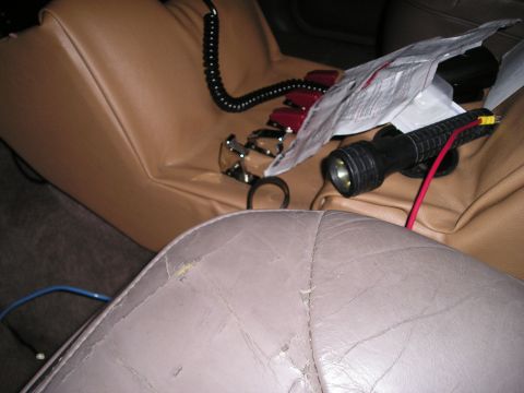 1996 Ford Bronco - Interior view shows tan seats with a flashlight and coiled cord, suggesting equipment or accessories within the vehicle.