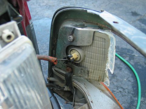 1995 Ford Bronco - Remove two bolts on back of corner lense. 7/16" Reverse process for reassembly.