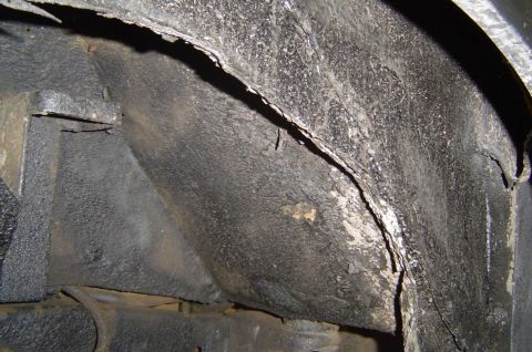 1974 Ford Bronco - Close-up view of the undercarriage of a vehicle, focusing on the wheel well area.