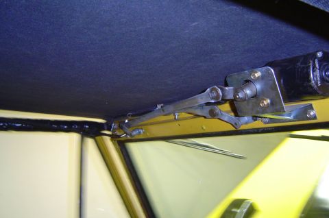 1974 Ford Bronco - Interior view of a yellow 1974 Ford Bronco, focusing on the windshield wiper assembly.