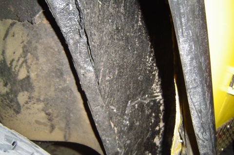 1974 Ford Bronco - This image shows the interior of a vehicle's wheel well, with a tire partially visible in the foreground.