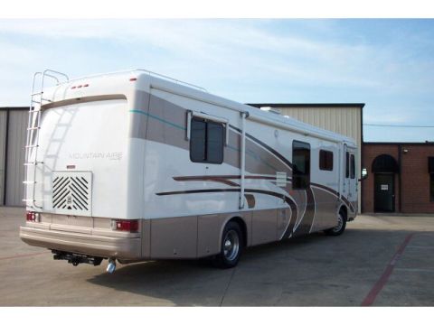 1989 Ford C-350 (Centurion Conversions) - This RV motorhome is shown from the rear, with a ladder and "MOUNTAIN AIRE" badging on the back.