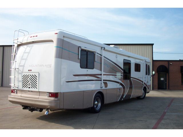 Beige Newmar Mountain Aire Class A motorhome, rear three-quarter view