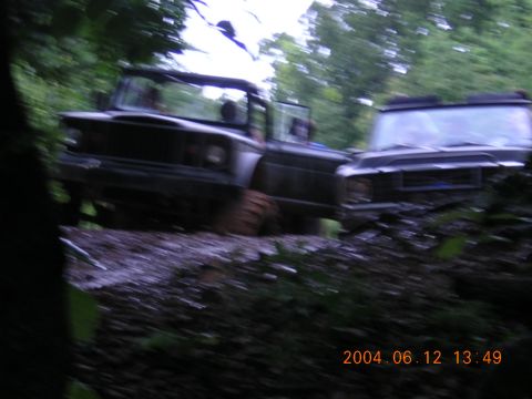 1984 Chevrolet Blazer - Two off-road vehicles are seen on a muddy path surrounded by trees, with a timestamp indicating the photo was taken on June 12, 2004.