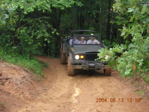 1984 Chevrolet Blazer - Military jeep navigates a muddy path through a wooded area, with a date stamp indicating June 12, 2004.