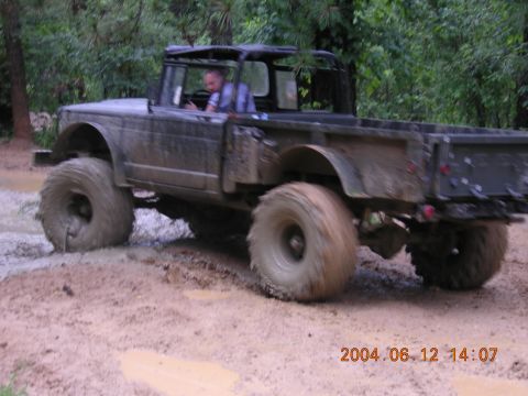 1984 Chevrolet Blazer - A heavily modified truck navigates a muddy off-road course.