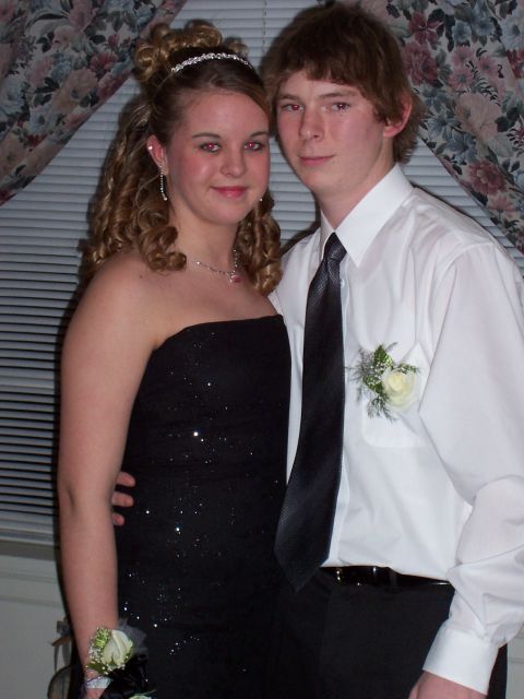 1994 Ford Bronco - A young couple poses for a photo, likely at a prom or formal dance, with floral curtains in the background.