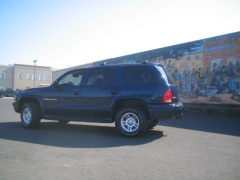 2001 Dodge Durango - A dark blue 2001 Dodge Durango is parked in front of a colorful mural on a sunny day.
