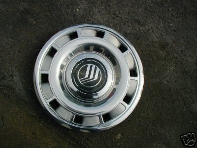 1991 Ford Crown Victoria LTD - A chrome hubcap with the Mercury Grand Marquis logo is shown, likely from a late 1980s or early 1990s model.
