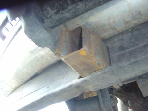 1993 Ford Bronco - Underside view of a rusted bracket on a vehicle frame.