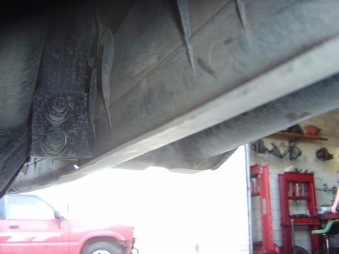 1993 Ford Bronco - Underside view of a red 1993 Ford Bronco, revealing its frame and suspension parts.