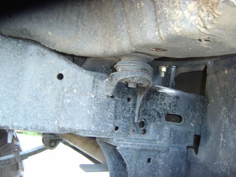 1993 Ford Bronco - Underside view of a vehicle's chassis and suspension system, with visible wear and tear.