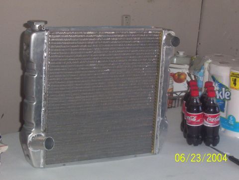 1974 Ford Mustang II - Radiator shown with beverages and household items. Date stamp visible in lower right corner.