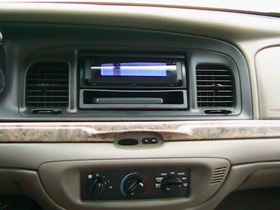 Crown Victoria dash center stack with aftermarket radio and rotary climate controls