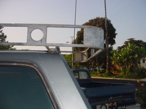 1988 Ford Bronco - Custom metal roof rack mounted on a gray SUV, with another vehicle visible in the background.