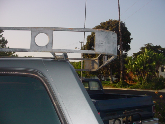 Custom metal roof rack over gray SUV rear window
