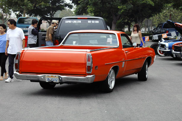 Orange Ford Ranchero coupe-utility, rear 3/4 view at a car show