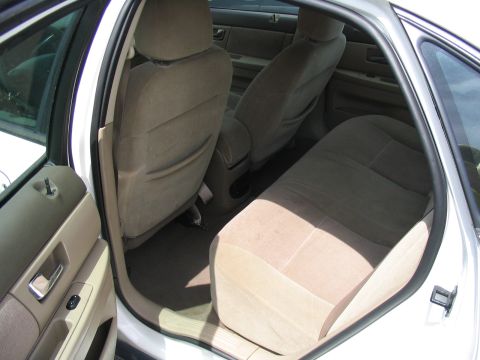 2000 Honda Accord - The interior of a car shows tan cloth seats and door panels, with a watermark at the bottom right.