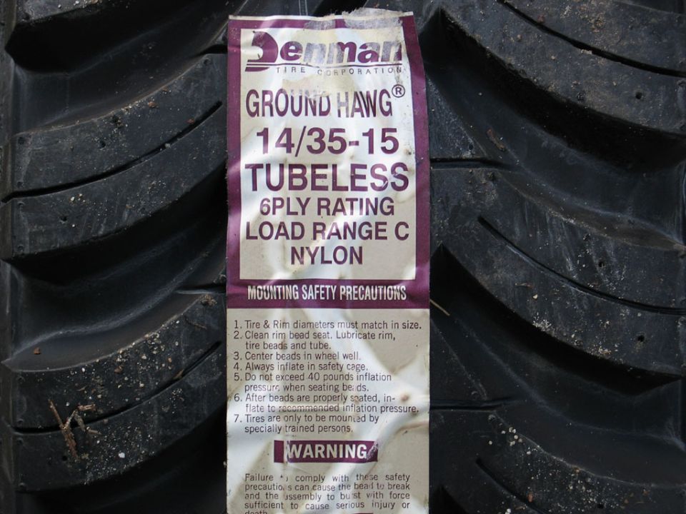 Denman Ground Hawg 14/35-15 tubeless tire label on the tread of a new mud tire