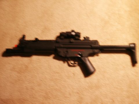 1991 Ford Bronco - This is a photo of a black airsoft gun with a scope and red markings.