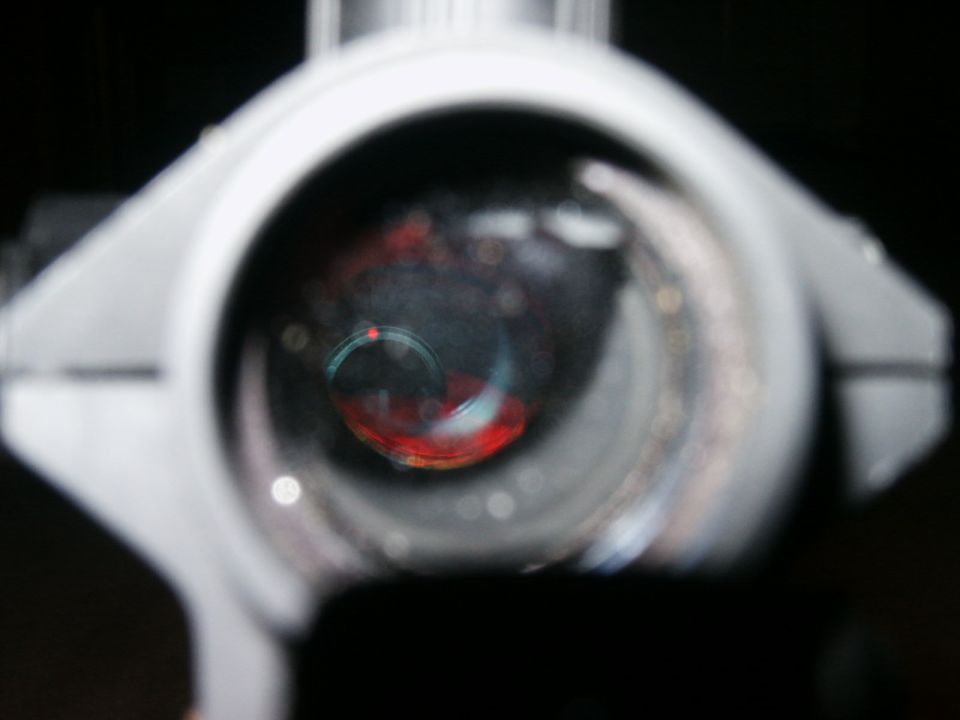 Close-up of a car's dashboard gauges, showing red and blue lights