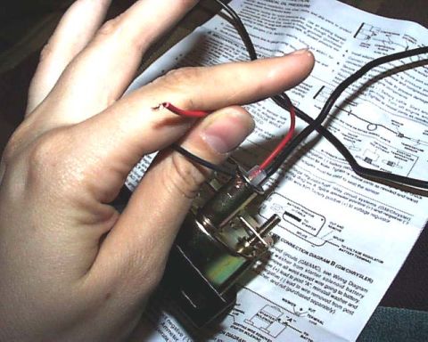1988 Ford E250 - A hand manipulates wires connected to a gauge, with a technical document providing installation instructions.