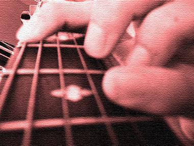 2000 Jeep Liberty - Close-up of a guitar fretboard with fingers on the strings. SUPERMOTORS.COM watermark visible.