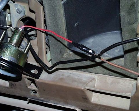 1988 Ford E250 - Close-up view of exposed wiring and a gauge within a vehicle's interior.