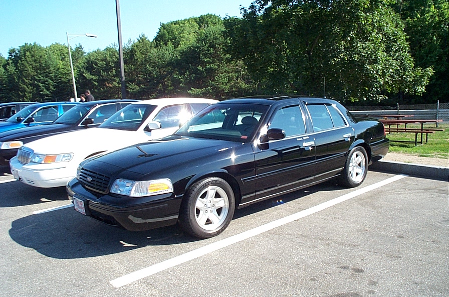 Black 2001 Ford Crown Victoria parked in a lot with other cars