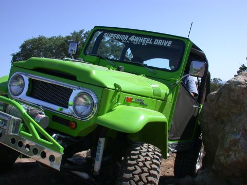 1996 Ford Bronco - Off-road vehicle with custom bumper and winch is shown navigating a rocky terrain.