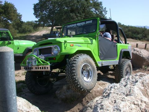 1996 Ford Bronco - This modified Toyota Land Cruiser navigates rocky terrain with a Jeep in the background.