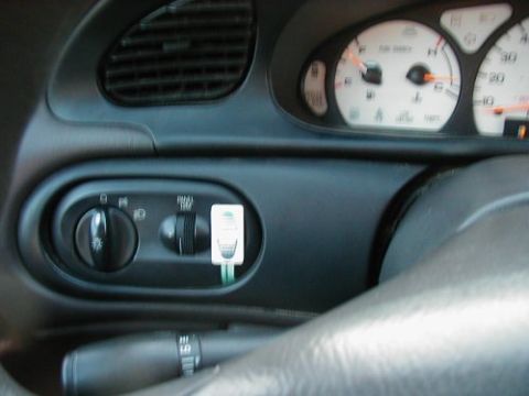 1997 Ford Taurus - The interior dashboard of a 1997 Ford Taurus features clear gauges and accessible light controls.