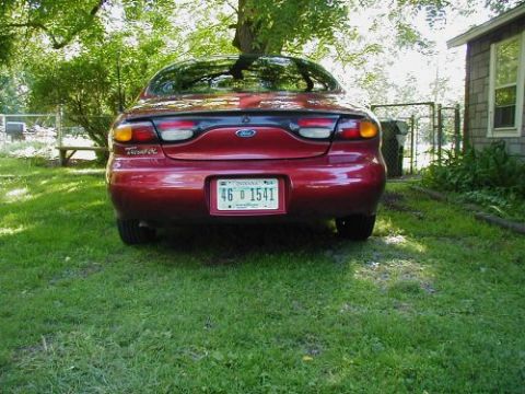 1997 Ford Taurus - Rear view of a red Ford Taurus with an Indiana license plate parked on a lawn.