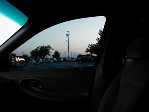 1997 Ford Taurus - View from inside a 1997 Ford Taurus, looking out at a parking lot with several other vehicles.