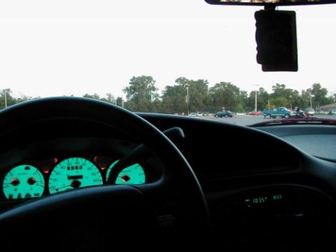 1997 Ford Taurus - Interior view of a 1997 Ford Taurus, with a parking lot scene visible through the windshield.