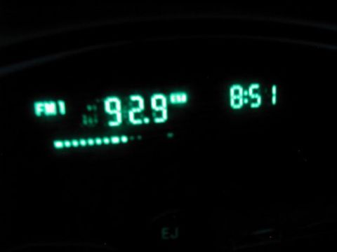 1997 Ford Taurus - A car's digital display shows the radio station and time.