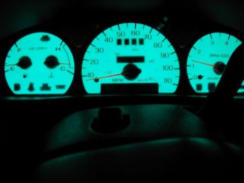1997 Ford Taurus - The glowing teal dashboard gauges display speed, RPM, fuel, and temperature.