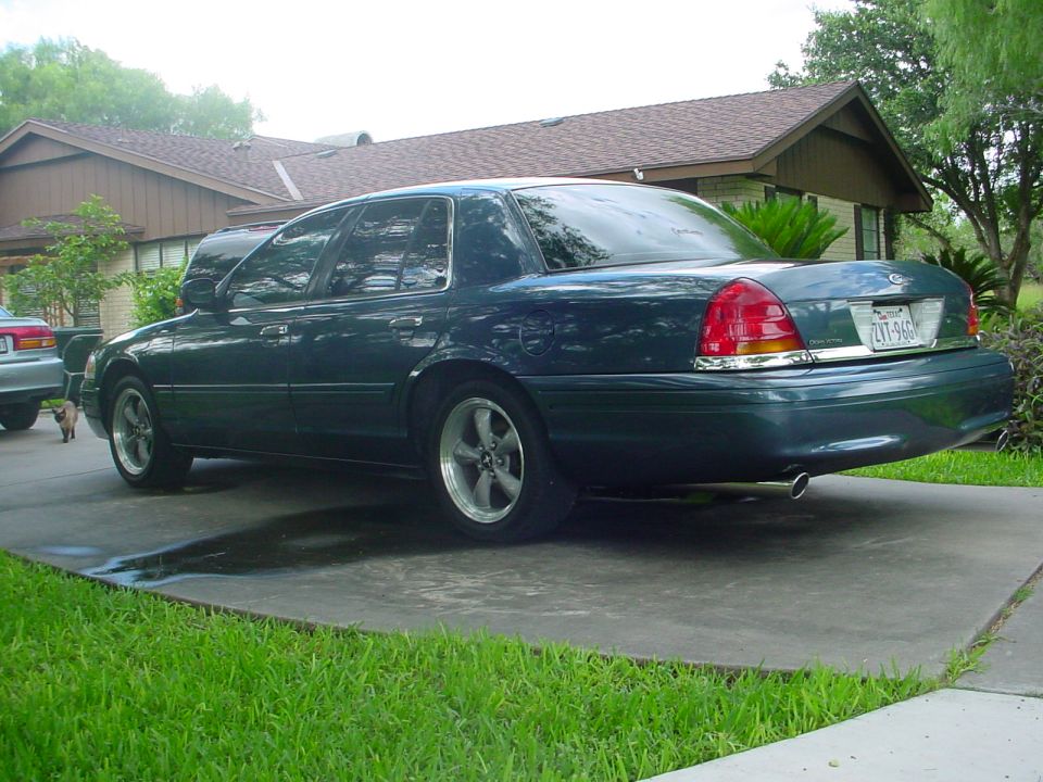 Dark green Mercury Grand Marquis sedan parked in a driveway